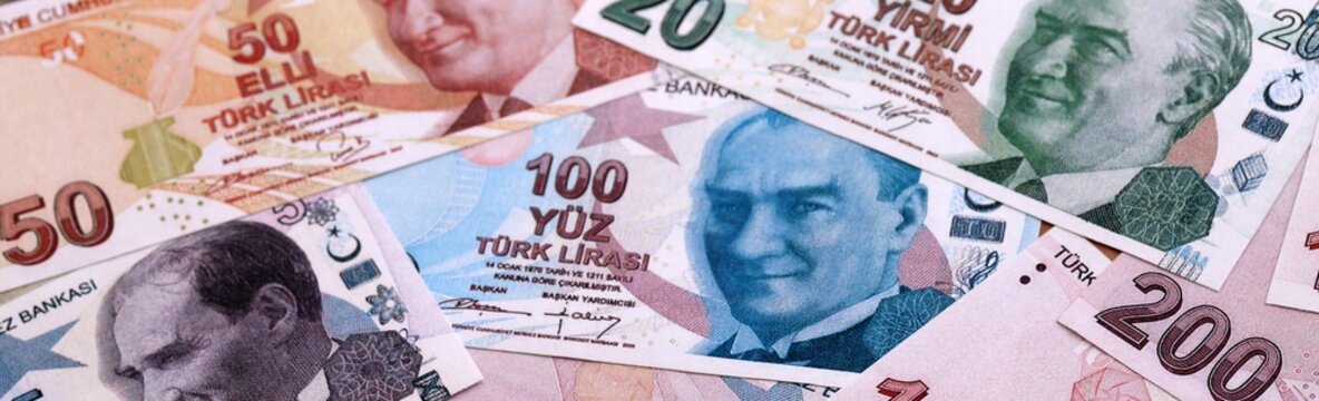 Turkish lira money bills pile on table. Turkey banknotes of TRY currency close up.