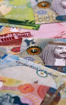 Bahraini dinar money bills pile on table. Bahrain banknotes of BHD currency close up.