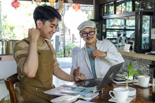 Modern small business digital technology, father and son cafe owner, young entrepreneur management, using laptop and tablet planning orders finance workflow efficiency technology business operation