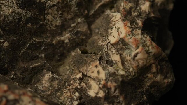 Close-up mineral rock with complex texture and earthy color patterns