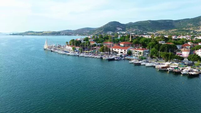 Scenic aerial view of a bustling harbor filled with sailboats and coastal town. Turkey, Izmir, Eski Foca
