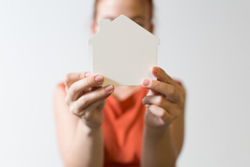 Obraz premium Person holding a white house symbol representing homeownership and dreams.