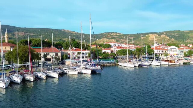 Idyllic Mediterranean harbor with sailboats and traditional boats docked. Turkey, Izmir, Eski Foca