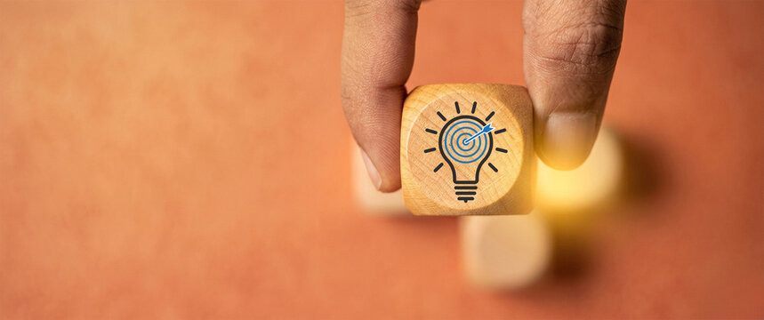 Focused business strategy concept. hand selecting idea block with light bulb target icon, representing goal-oriented thinking, innovation planning, decision making, strategic clarity organizations