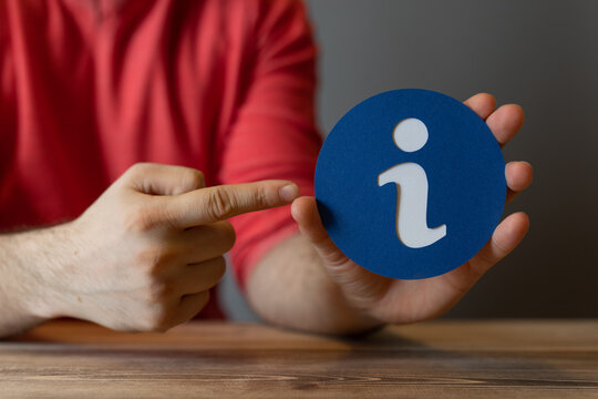 Hand holding an info symbol, suggesting knowledge and guidance