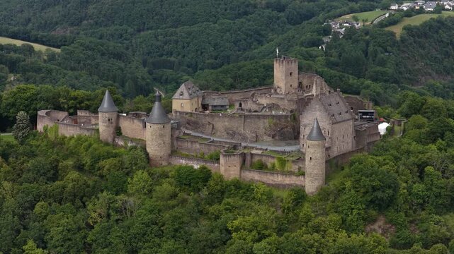 Aerial view of bourscheid castle in luxembourg slowly orbiting the fortress