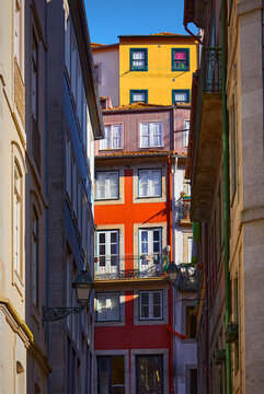 Porto, Portugal. Cosy street with traditional colorful houses. Windows and sun. Sunny summer day. Residential porto city district beautiful antique portugal buildings. Travel destination in Europe..