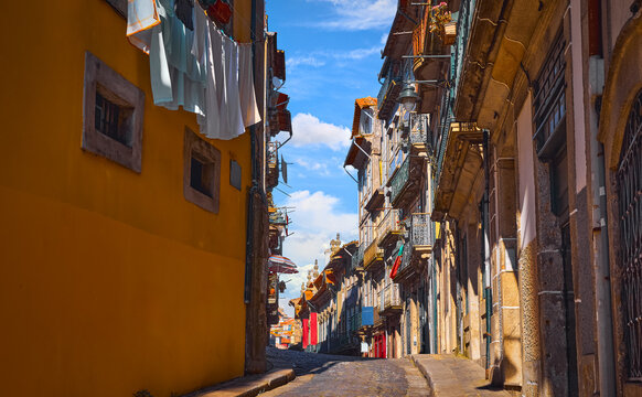 Porto, Portugal. Cosy street with traditional houses. Windows and doors. Sunny summer day. Residential district with beautiful antique buildings.
