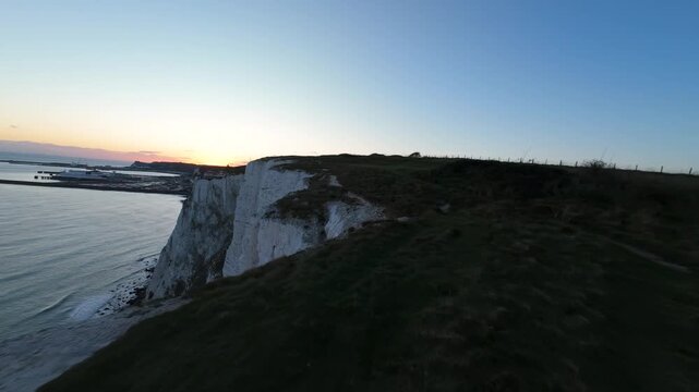 Drone flying along the iconic white cliffs of dover at sunset