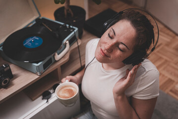 young man with headphones, enjoying coffee in the morning, retro music mornings  © Dejan