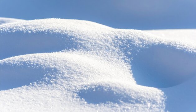 Close up of pristine white snowdrifts under clear blue sky background