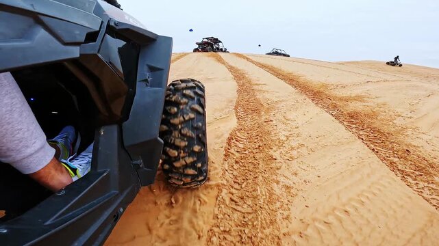 Dynamic pov from buggy driving across Dubai desert dunes textured sand tracks