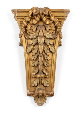 Ornamental gold wood corbel with intricate acanthus leaf carving. Antique architectural wall bracket for interior decoration. Decorative vintage furniture element with patina finish.