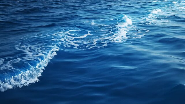 Deep Blue Ocean Waves Crashing with White Foam and Sunlight Reflections.