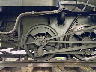 Closeup of vintage locomotive parts. Weathered steel railway components with oil and rivets © Vladimir