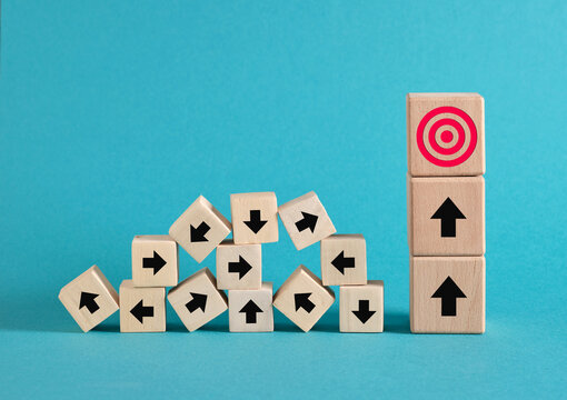 Wooden blocks pointing to clear business goal direction, business success in chaos