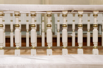 Fototapeta premium Decorative wooden altar railing inside historic Christian church interior