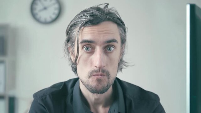 Unbearably bored office worker shaking head negatively at workplace, man with dark graying hair in softly lit minimalist office showing deep concentration, skeptical curiosity, and calm resignation