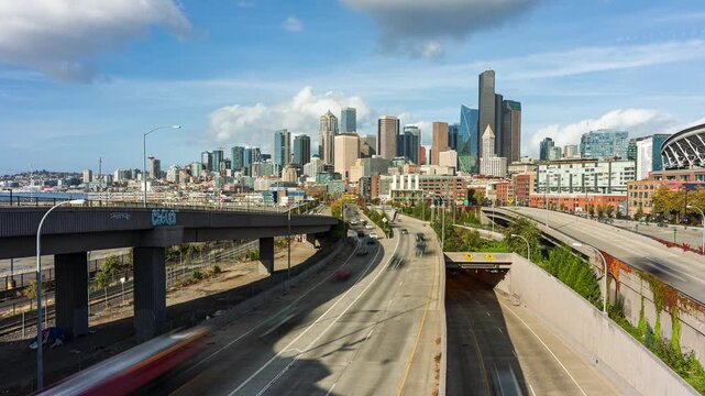 Time lapse cityscape of Seattle skyline with freeway traffic motion.