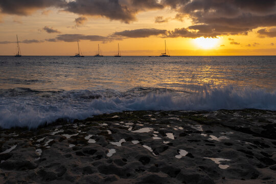 A spectacular sunset over the golden sand and Atlantic ocean seen from the popular Bikini beach at the island of Sal in Cape Verde. It is a nice stretch of beach with a calm cove area that's great for