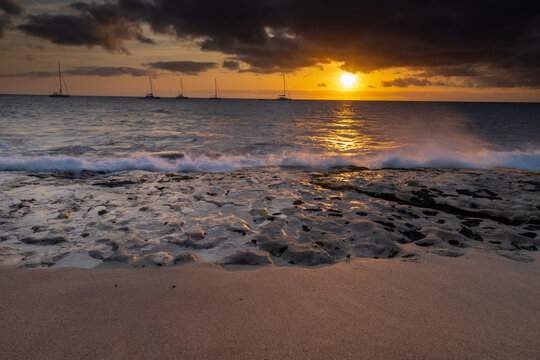 A spectacular sunset over the golden sand and Atlantic ocean seen from the popular Bikini beach at the island of Sal in Cape Verde. It is a nice stretch of beach with a calm cove area that's great for