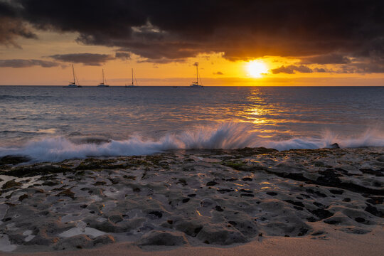 A spectacular sunset over the golden sand and Atlantic ocean seen from the popular Bikini beach at the island of Sal in Cape Verde. It is a nice stretch of beach with a calm cove area that's great for