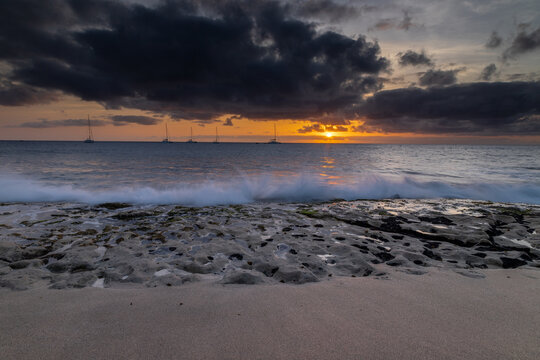 A spectacular sunset over the golden sand and Atlantic ocean seen from the popular Bikini beach at the island of Sal in Cape Verde. It is a nice stretch of beach with a calm cove area that's great for