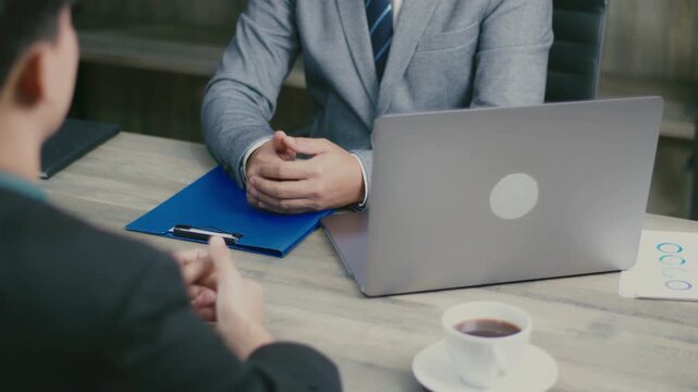 Professional job interview in modern office, HR manager interviewing candidate at desk with laptop, business recruitment and hiring process