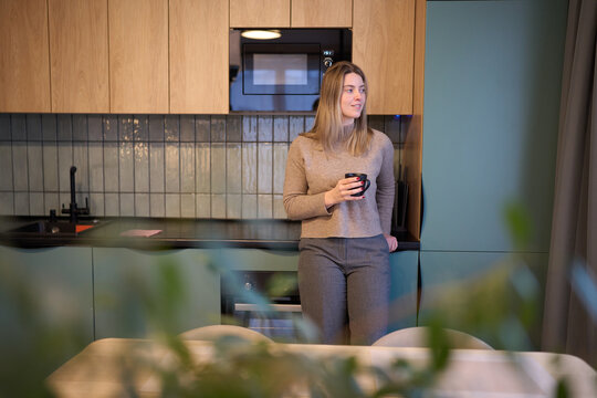 Calm morning pause in kitchen with soft reflective warmth