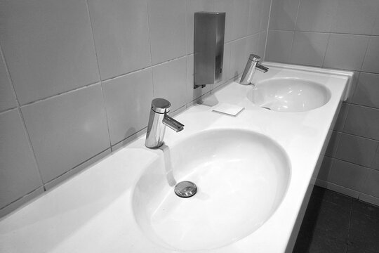 Modern Minimalist Bathroom Sink Design with Dual Faucet Setup