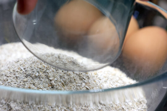 Baking Preparation with Fresh Eggs and Flour in a Glass Bowl Culinary Essentials