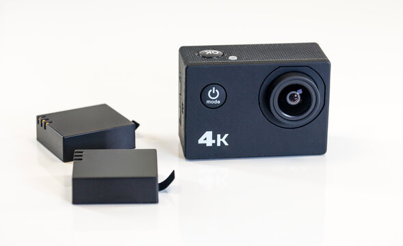 4k action camera with two batteries on white background