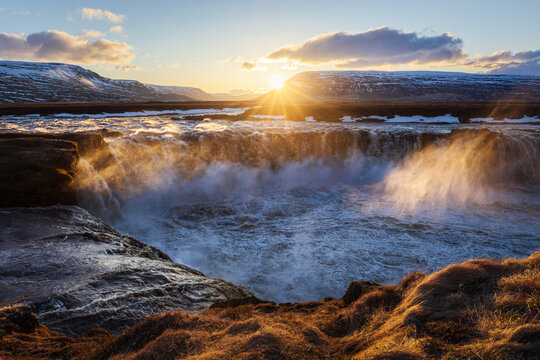 Godafoss waterfall in north Iceland at sunset with strong wind and turbulent waters