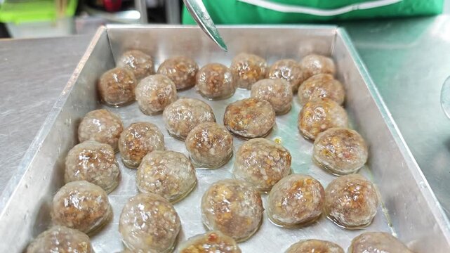 Close-up of cooked homemade tapioca pearls filled with savory pork stuffing.
