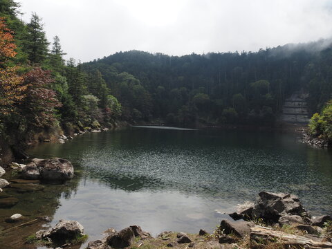 In late September, Mount Kitayokodake in the Northern Yatsugatake range offers a highland mountain landscape of rocky ridges, subalpine conifer forests, and early autumn scenery in Nagano, Japan.