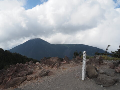 In late September, Mount Kitayokodake in the Northern Yatsugatake range offers a highland mountain landscape of rocky ridges, subalpine conifer forests, and early autumn scenery in Nagano, Japan.