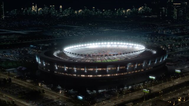 Football Championship Match at Packed Stadium at Night in a City. Cheering Crowds of Fans at Soccer Spectacle, Major Cup World Sport Event Arena. Aerial Wide Arc Shot