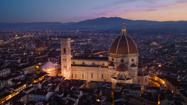drone shot of evening Florence with illuminated iconic Duomo di Florence,tourist landmark, Renaissance cathedral in Florence, travel in Tuscany, Italy