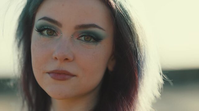Beautiful alternative woman with piercing looking at camera