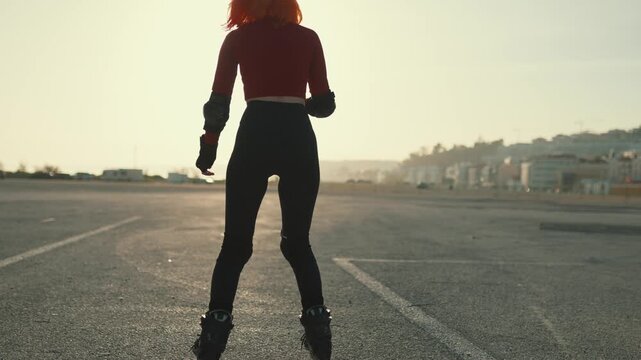 Young woman rollerblading during a beautiful sunset