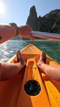 Kayaking Water Beach Person Paddling Orange Kayak Towards Sunny Shore Cliffs Vertical video