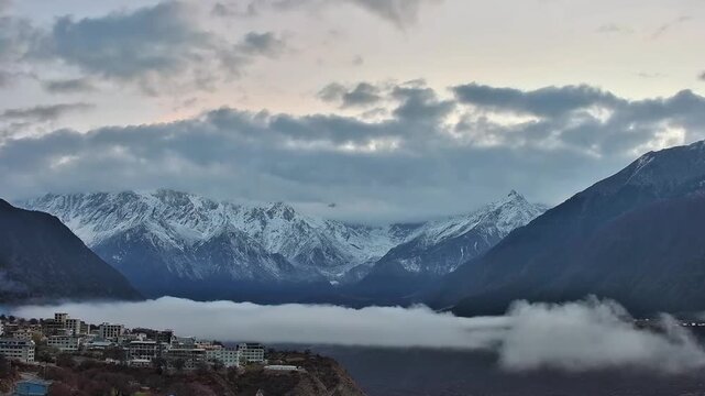 The first light of morning hitting the clouds and snow covered summit of Namcha Barwa in a 30 second time lapse.