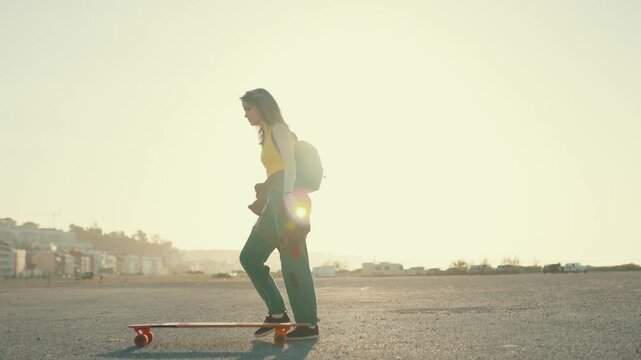Young woman longboarding during a sunny day