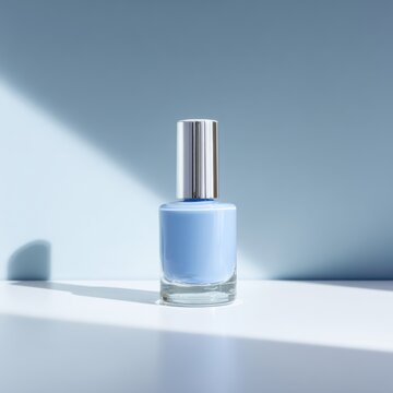Minimalist Blue Nail Polish Bottle with Silver Cap on White Surface.