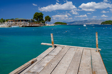 wooden pontoon in Ksamil, Albania, turquoise beach and touristic resort © eric
