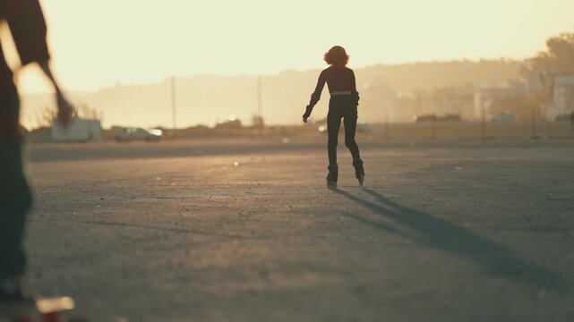 People skateboarding and roller skating at sunset