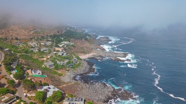 Aerial orbit over the small, exclusive village of Pite near Papudo, hidden among the clouds, Valparaiso, Chile