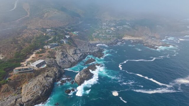 Aerial orbit establishing the coastline of Pite, an exclusive village with luxury residential properties near Papudo, Chile