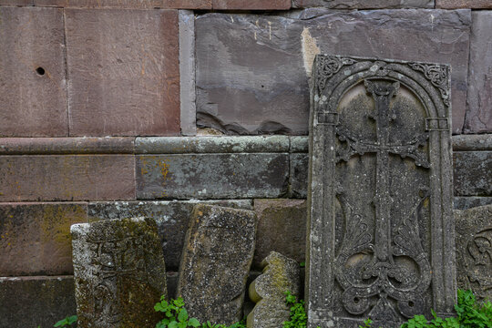 Old Armenian khachkars. Cross on a rock. Stone with a cross.