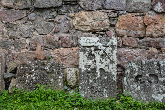 Old Armenian khachkars. Cross on a rock. Stone with a cross.